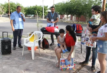 El personal sanitario que utiliza un parlante para invitar a los vecinos a que vacunen a sus hijos