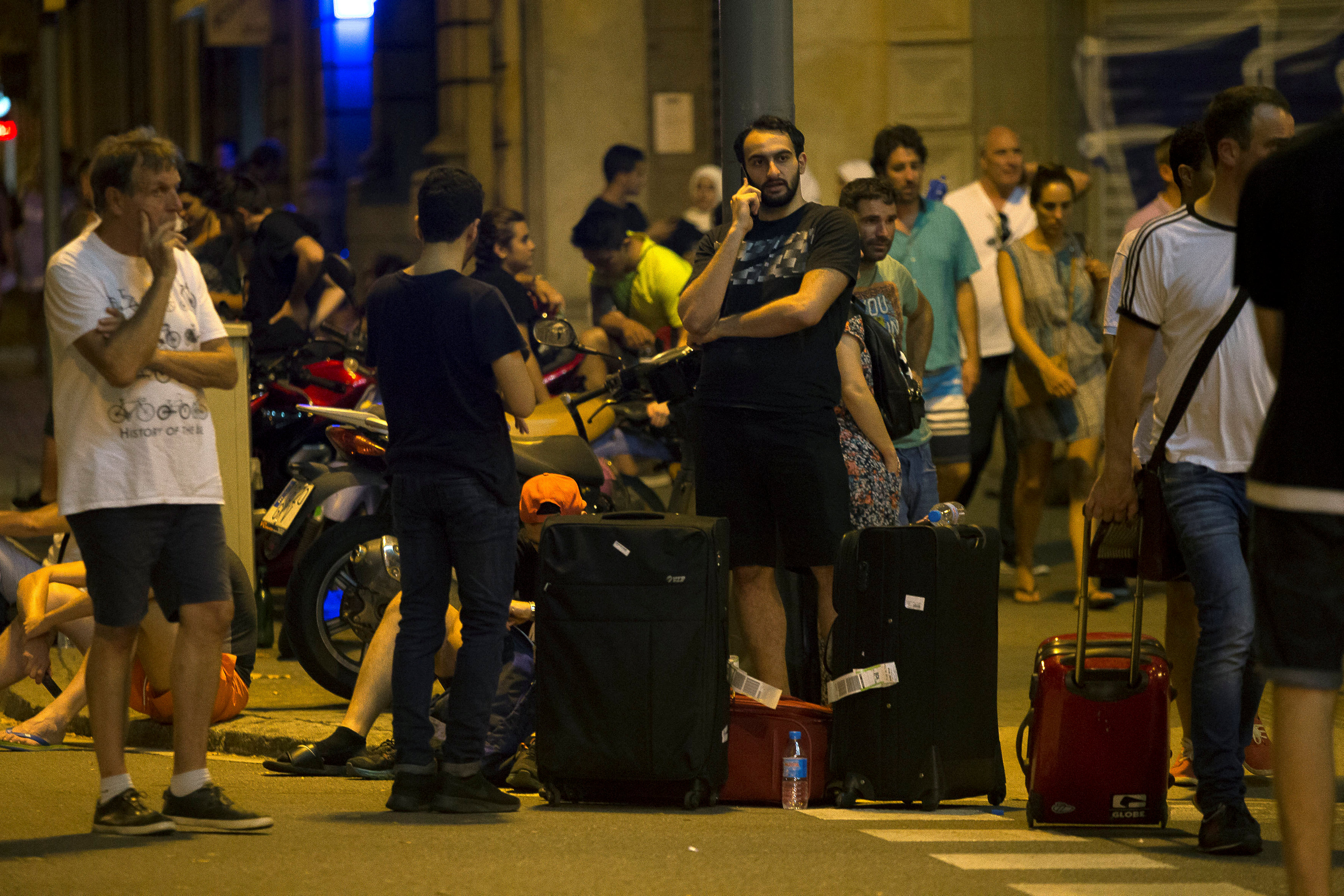 People wait to enter the area after a van crashed into pedestrians near the Las Ramblas avenue in central Barcelona - NARCH/NARCH30